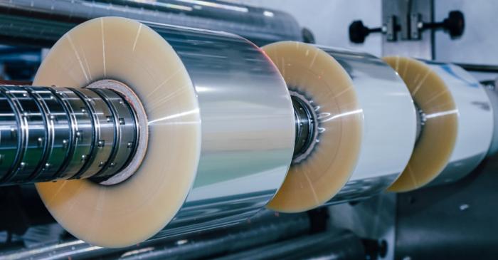 Slitting machine processing multiple rolls in parallel